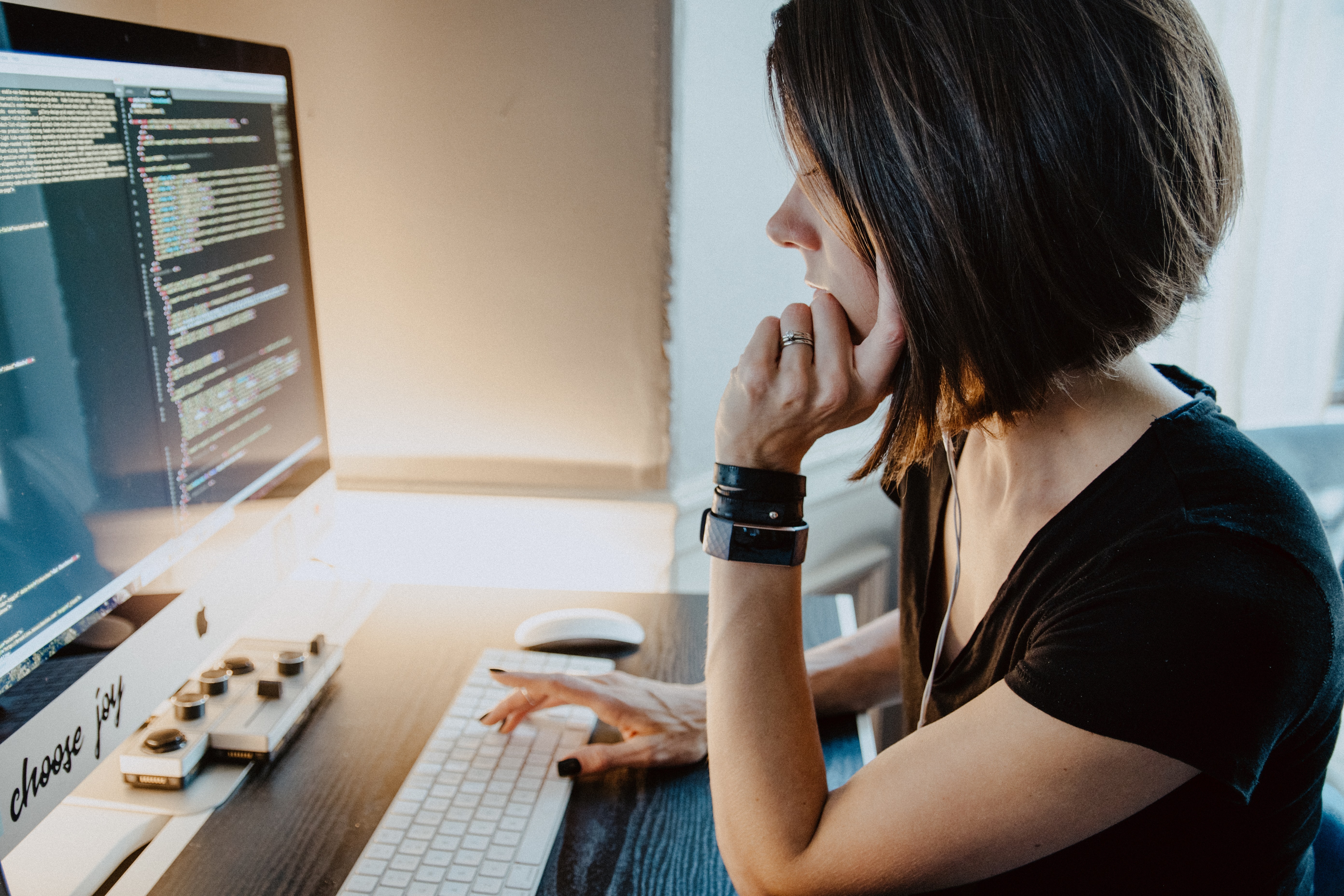 Female NetSuite developer at her computer coding